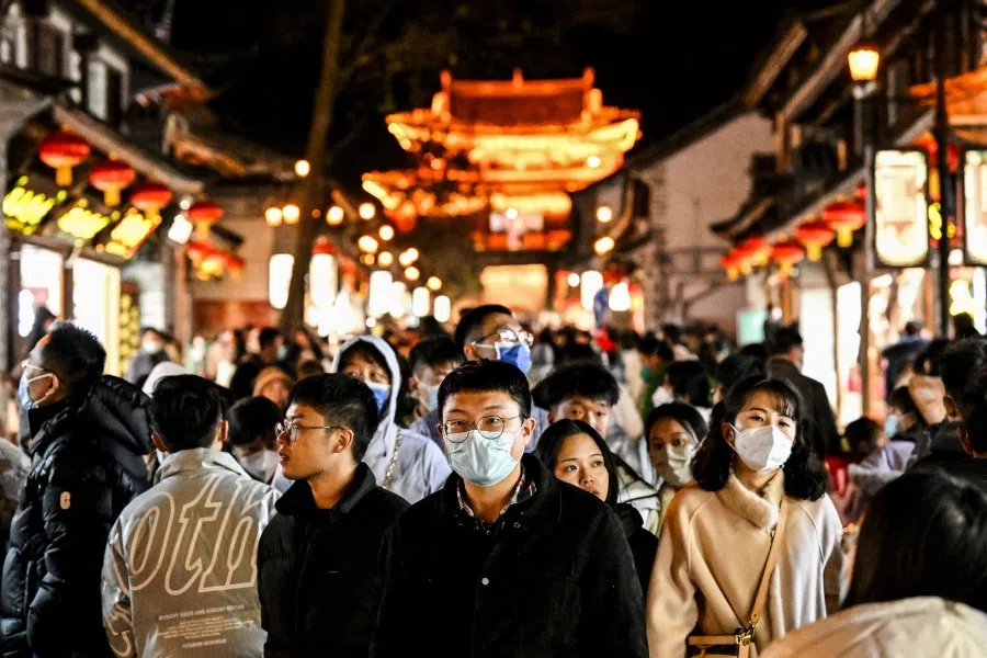 This photo taken on 14 January 2023 shows people walking down the street in Dali town, a township-level division in Dali City, in China's northwest of Yunnan province. (Noel Celis/AFP)