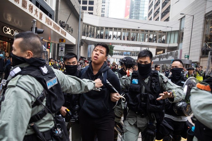 Riot police detain a demonstrator at Pedder Street during a protest in the Central district of Hong Kong, January 2020. (Kyle Lam/Bloomberg)
