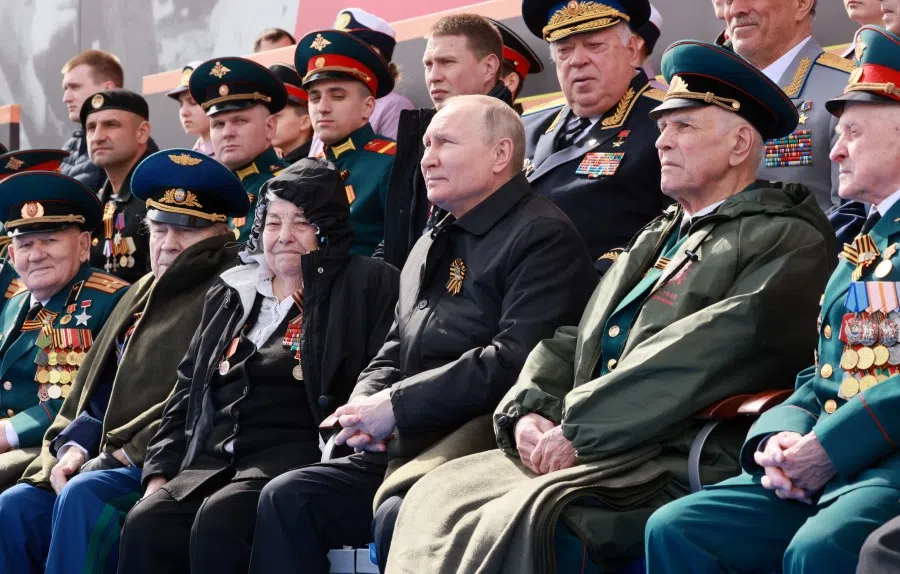Russian President Vladimir Putin watches a military parade on Victory Day, which marks the 77th anniversary of the victory over Nazi Germany in World War II, in Red Square in central Moscow, Russia, 9 May 2022. (Mikhail Metzel/Sputnik/Pool via Reuters)