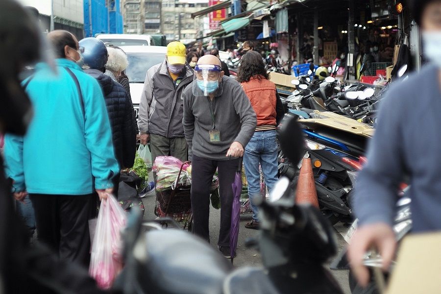 An elderly man walks at Wanda road traditional market in Taipei, Taiwan, on 25 January 2022. (Sam Yeh/AFP)