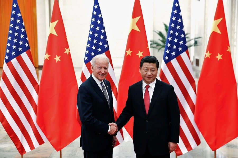 In this file photo taken on 4 December 2013, Chinese President Xi Jinping shakes hands with then-US Vice President Joe Biden (left) inside the Great Hall of the People in Beijing, China. Since his inauguration, Biden has yet to speak to Xi on the phone. (Lintao Zhang/Pool/File Photo/Reuters)