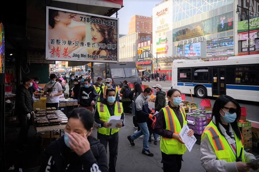 In this photo taken on 23 March 2021, members of a volunteer anti-hate crime group patrol in the Flushing neighbourhood of Queens, New York, US. (Ed Jones/AFP)