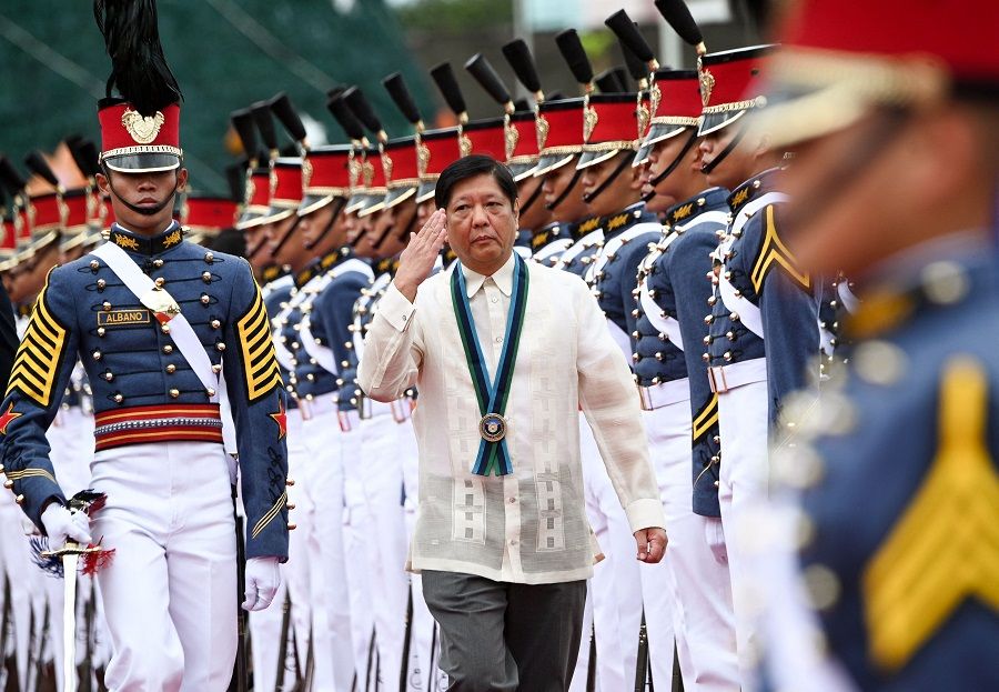Philippine President Ferdinand Marcos Jr. (centre) salutes as he troops the line during the 87th anniversary celebration of the Armed Forces of the Philippines, at the military headquarters in Quezon City in suburban Manila on 19 December 2022. (Ted Aljibe/AFP)