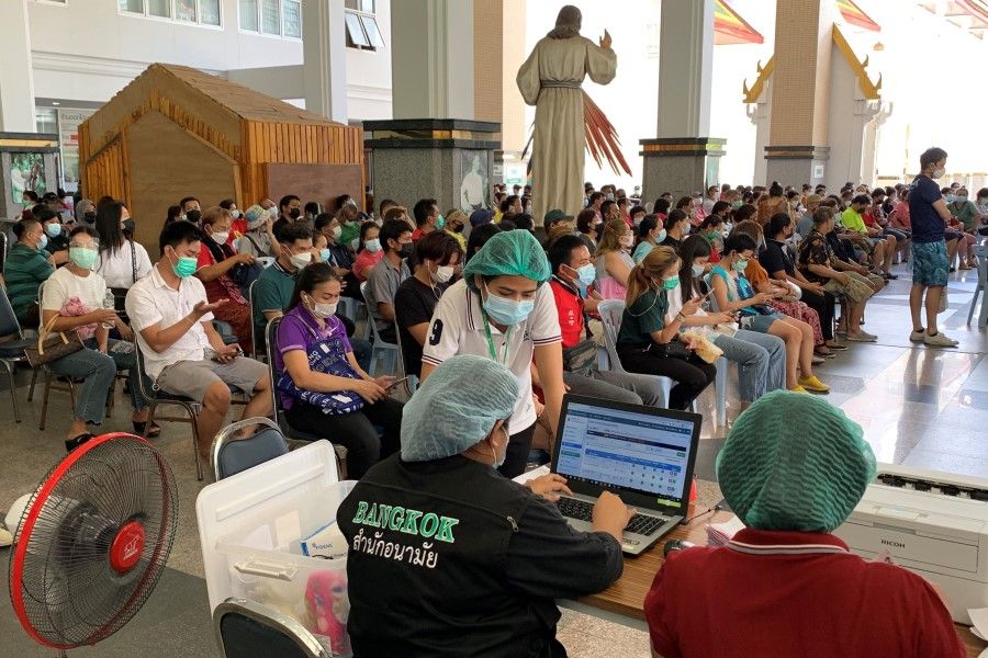 People wait to receive doses of China's Sinovac Covid-19 coronavirus vaccine at the Holy Redeemer Church in Bangkok on 30 May 2021. (Romeo Gacad/AFP)
