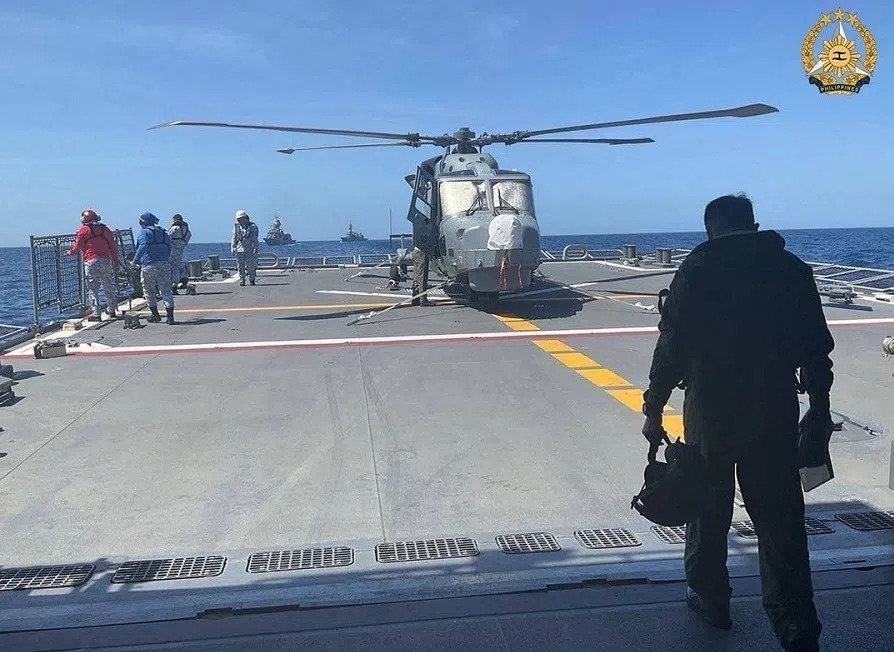 In this handout photo taken and received on 7 April 2024 from the Armed Forces of the Philippines (AFP), a Philippine Navy AW159 Wildcat helicopter pilot walks toward BRP Antonio Luna's helideck to conduct his pre-flight inspection procedure on the helicopter during the first Multilateral Maritime Cooperative Activity between the Philippines, US, Australia and Japan, in the South China Sea. (Armed Forces of the Philippines/AFP)