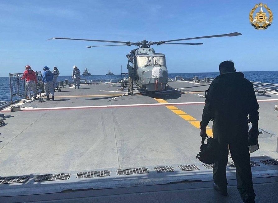 In this handout photo taken and received on 7 April 2024 from the Armed Forces of the Philippines (AFP), a Philippine Navy AW159 Wildcat helicopter pilot walks toward BRP Antonio Luna's helideck to conduct his pre-flight inspection procedure on the helicopter during the first Multilateral Maritime Cooperative Activity between the Philippines, US, Australia and Japan, in the South China Sea. (Armed Forces of the Philippines/AFP)