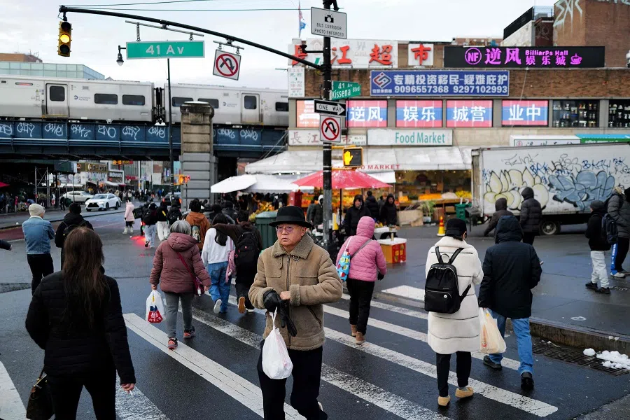 People walk in a street of the Flushing neighborhood in the Queens borough of New York City on 6 January 2025. (Charly Triballeau/AFP)