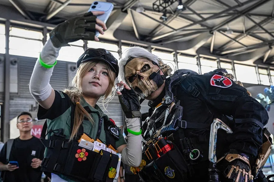 Cosplayers take selfie photos at the ChinaJoy conference, in Shanghai on 31 July 2026.