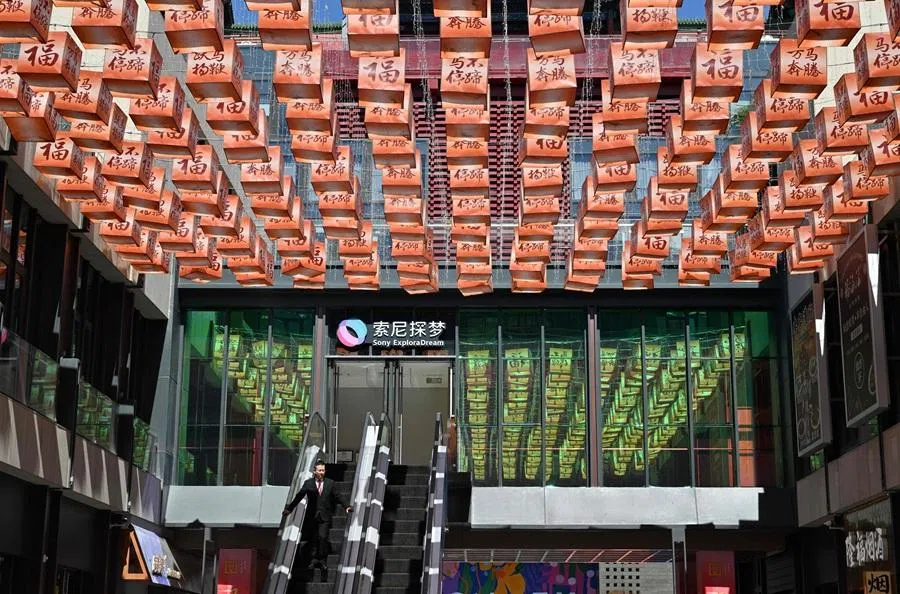 A man visits a shopping centre in Beijing on 7 April 2026. (Adek Berry/AFP)