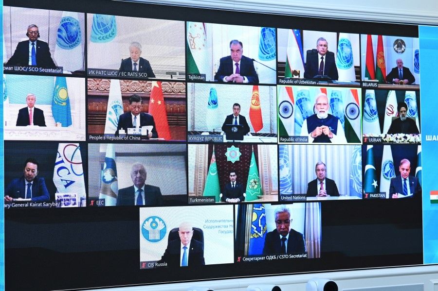 Leaders of states and officials of the Shanghai Cooperation Organisation (SCO) are seen on a screen during a summit via a video conference at the Kremlin in Moscow, Russia, 4 July 2023. (Sputnik/Alexander Kazakov/Kremlin via Reuters)