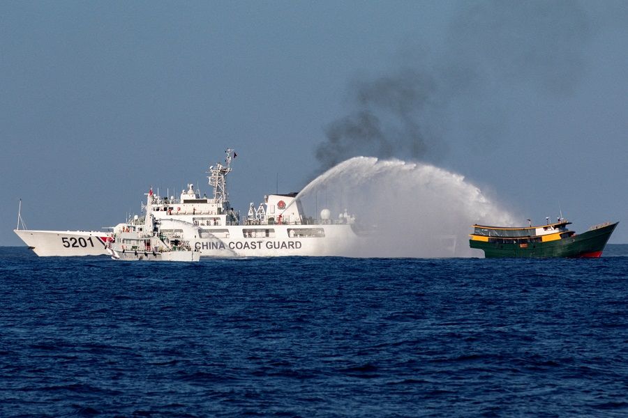 Chinese Coast Guard vessels fire water cannons towards a Philippine resupply vessel Unaizah May 4 on its way to a resupply mission at Second Thomas Shoal in the South China Sea, on 5 March 2024. (Adrian Portugal/Reuters)