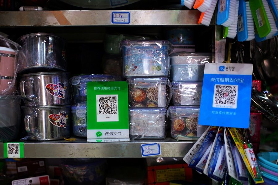 QR codes for WeChat Pay and Alipay are seen at a market in Beijing, China, 18 September 2020. (Tingshu Wang/Reuters)