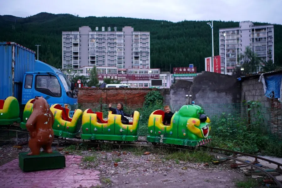 Children play at a makeshift playground near residential buildings in Yuexi county, Liangshan Yi Autonomous Prefecture, Sichuan province, China, 10 September 2020. (Tingshu Wang/Reuters)