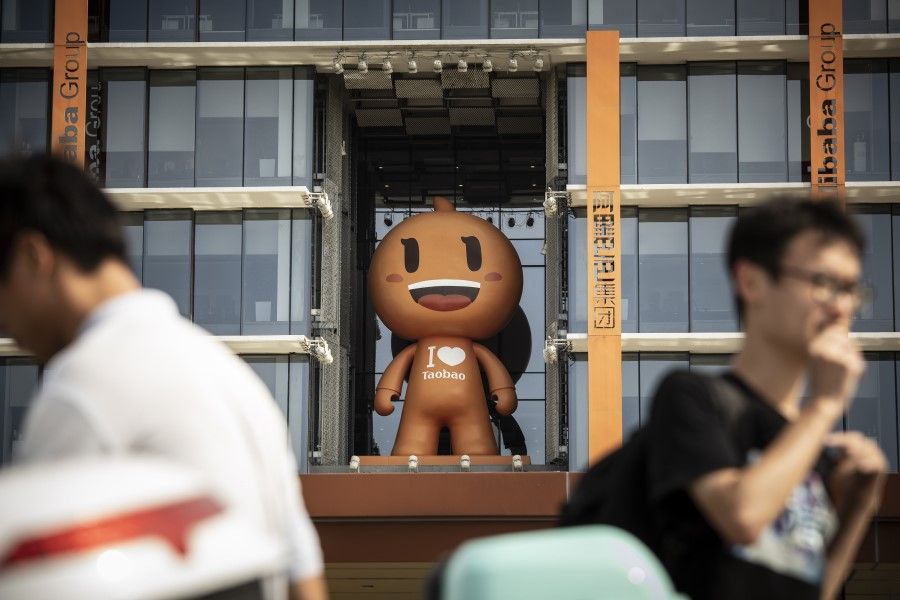 People walk past the mascot for the Taobao e-commerce platform at the headquarters of Alibaba Group in Hangzhou, China on 8 May 2021. (Qilai Shen/Bloomberg)