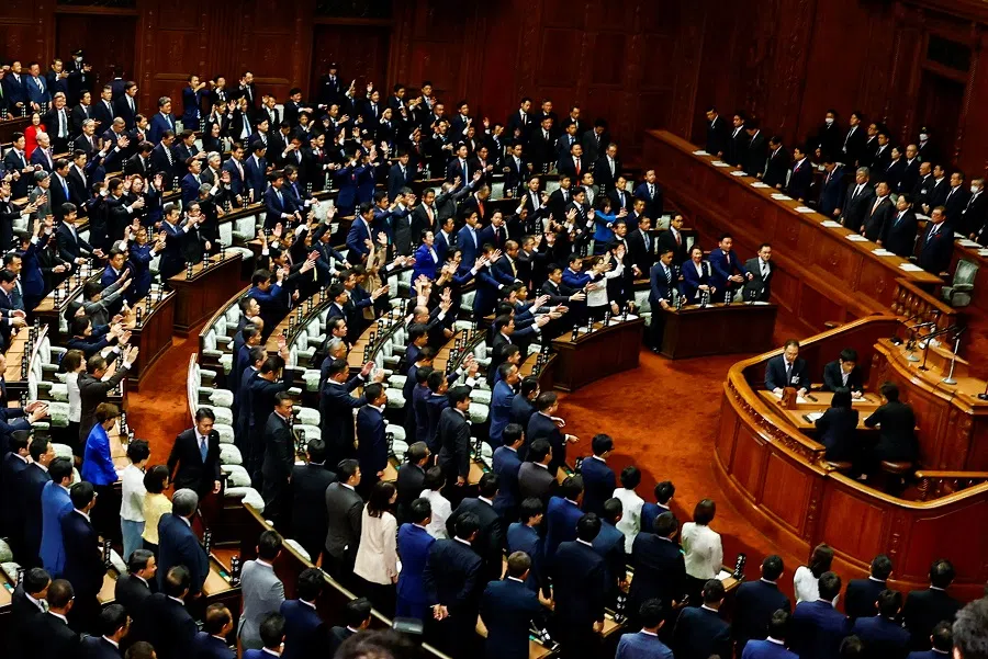 Lawmakers raise their hands and shout “banzai” after the dissolution of the lower house was announced at the Parliament in Tokyo, Japan, on 9 October 2024. (Issei Kato/Reuters)