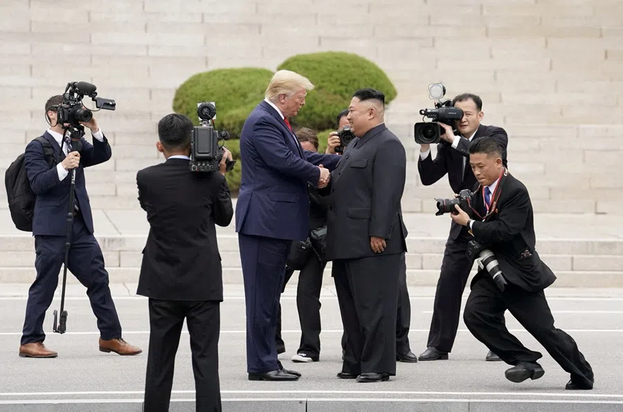 US President Donald Trump meets with North Korean leader Kim Jong Un at the demilitarised zone separating the two Koreas, in Panmunjom, South Korea, 30 June 2019. (Kevin Lamarque/Reuters)