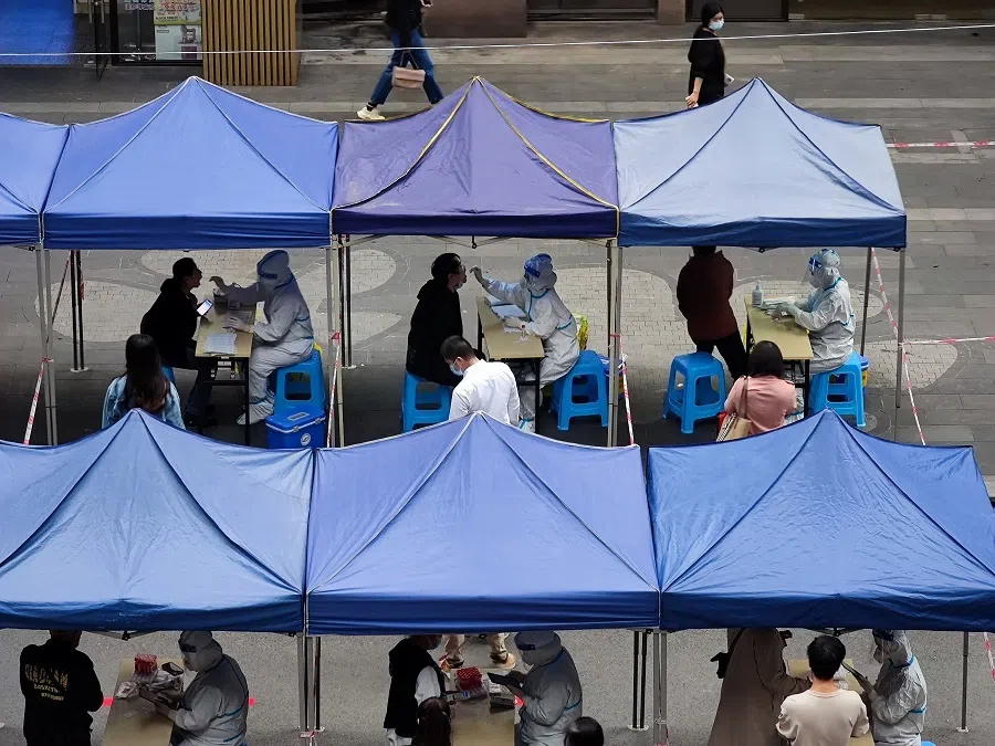 Medical workers take swab samples from residents for nucleic acid test for Covid-19, at a testing site in Chongqing, China, on 3 November 2022. (China Daily via Reuters)