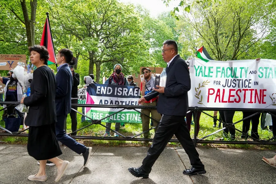 People protest the conflict between Israel and the Palestinian Islamist group Hamas, across the entrance to Yale, prior to commencement at Yale University in New Haven, Connecticut, US, on 20 May 2024.  (Michelle McLoughlin/Reuters)