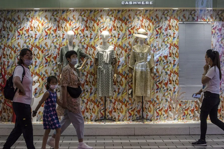 Shoppers and pedestrians walk past a store at Nanjing Road in Shanghai, China on 6 June 2021. (Qilai Shen/Bloomberg)