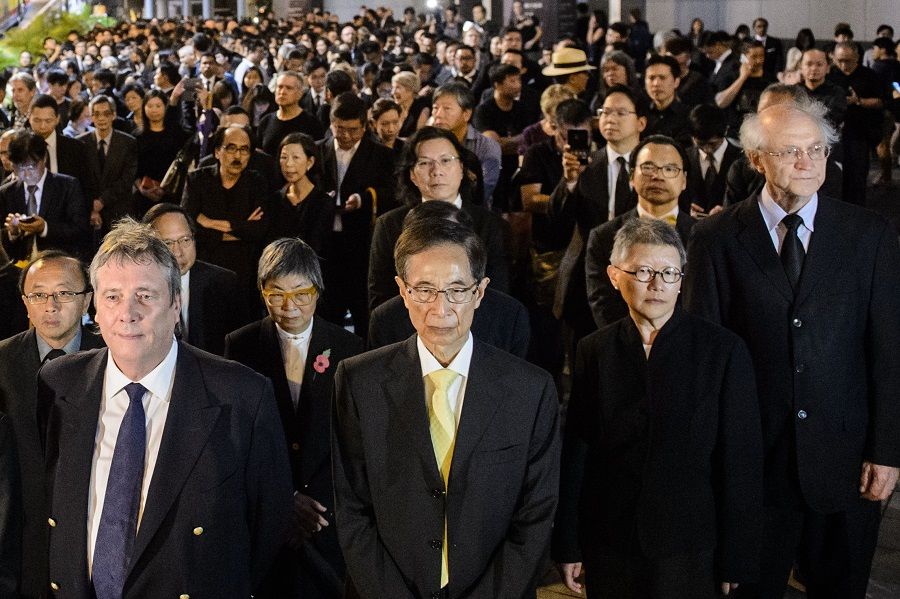 This file photo taken on 8 November 2016 shows members from the legal sector, including (front, left to right) senior counsel Graham Harris, former lawmaker Martin Lee, senior counsel Gladys Li and solicitor John Clancey, join other lawyers and law students in a silent march in protest at a ruling by China which effectively barred two pro-independence legislators from taking office in Hong Kong. (Anthony Wallace/AFP)