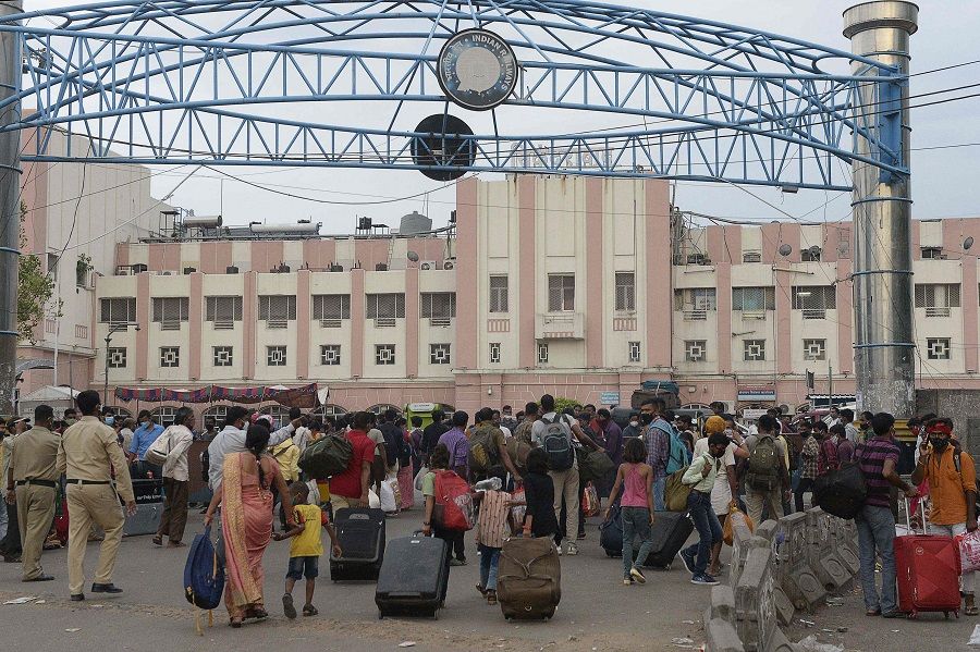 People wait outside a railway station to return home during a lockdown imposed to curb the spread of the Covid-19 coronavirus, in Secunderabad the twin city of Hyderabad, India, 31 May 2021. (Noah Seelam/AFP)