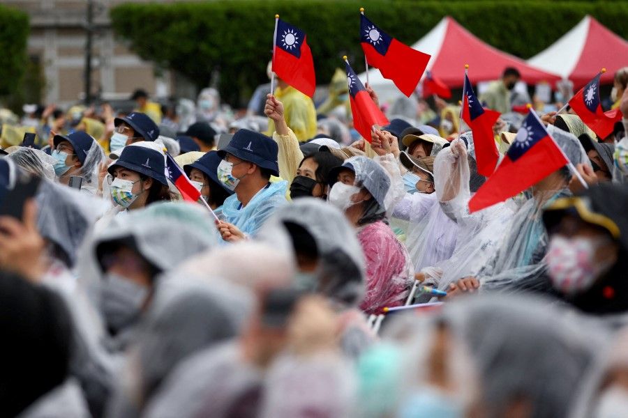 People hold Taiwanese flags during National Day celebrations in Taipei, Taiwan, 10 October 2022. (Reuters/Ann Wang)