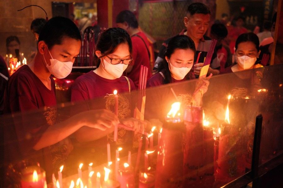 People light candles at the Toa Se Bio temple in Jakarta on 10 February 2024, the first day of the Lunar New Year of the Dragon. (Yasuyoshi Chiba/AFP)