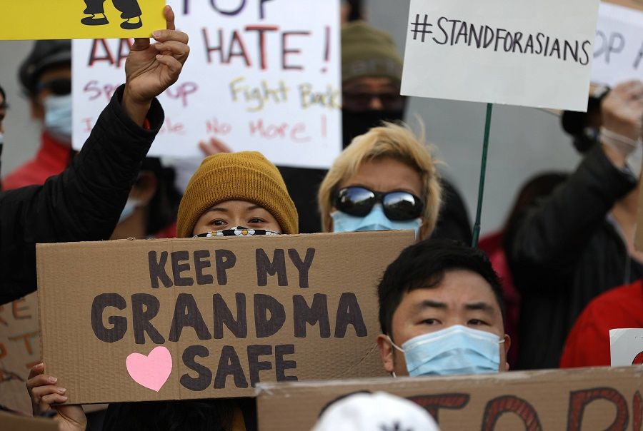 People hold signs during a rally in solidarity with Asian hate crime victims outside of the San Francisco Hall of Justice on 22 March 2021 in San Francisco, California, US. (Justin Sullivan/Getty Images/AFP)