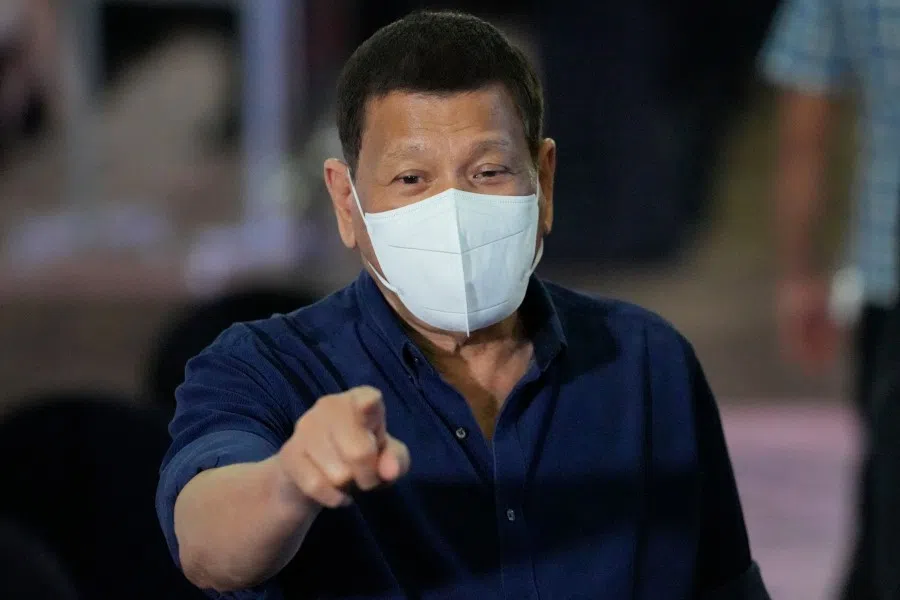 Philippine President Rodrigo Duterte gestures as he accompanies some of PDP-Laban's senators slate for next year's elections with the Commission on Elections in Manila on 8 October 2021. (Aaron Favila/AFP)