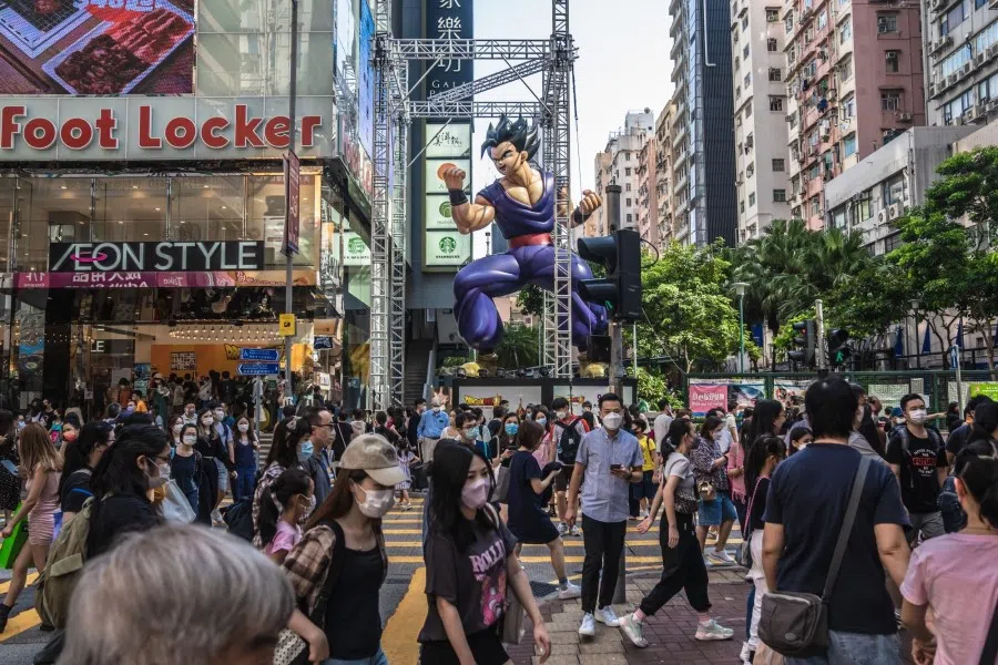 Pedestrians cross a road in Hong Kong, China, on 15 October 2022. (Lam Yik/Bloomberg)