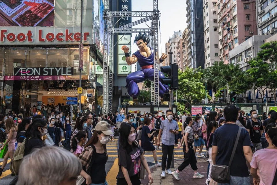 Pedestrians cross a road in Hong Kong, China, on 15 October 2022. (Lam Yik/Bloomberg)