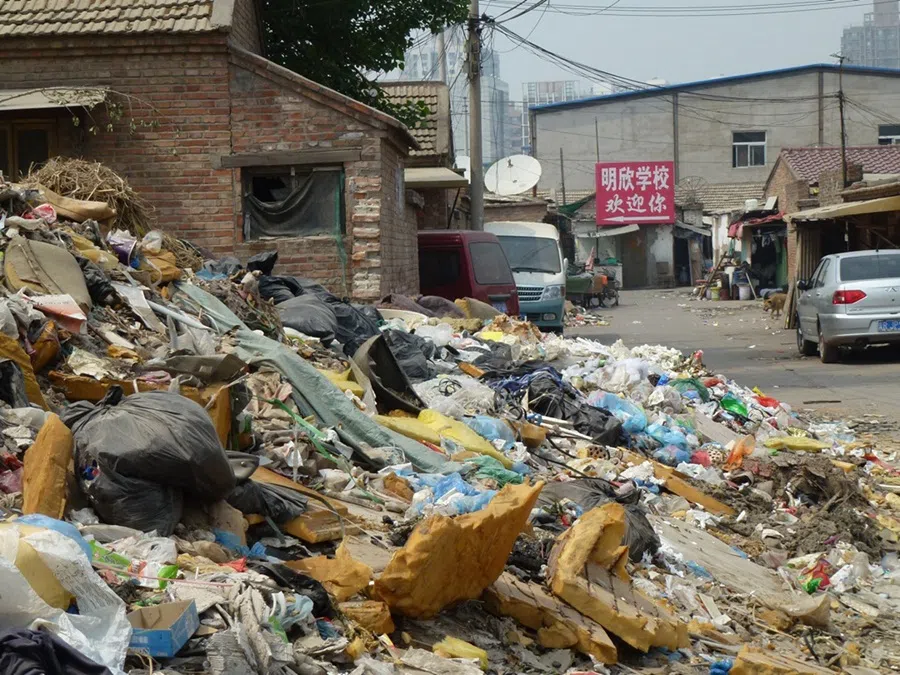 In this shot taken in 2012, towering heaps of plastic bottles, old rags and bricks surround the area around the Dongxiaokou village in north Beijing.  (SPH Media)