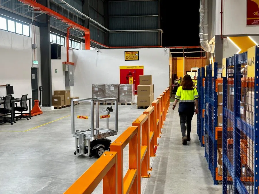 A robot picker follows a DHL Supply Chain worker to extract sensitive equipment for a semiconductor client from the firm’s Penang Logistics Hub 4. (SPH Media)
