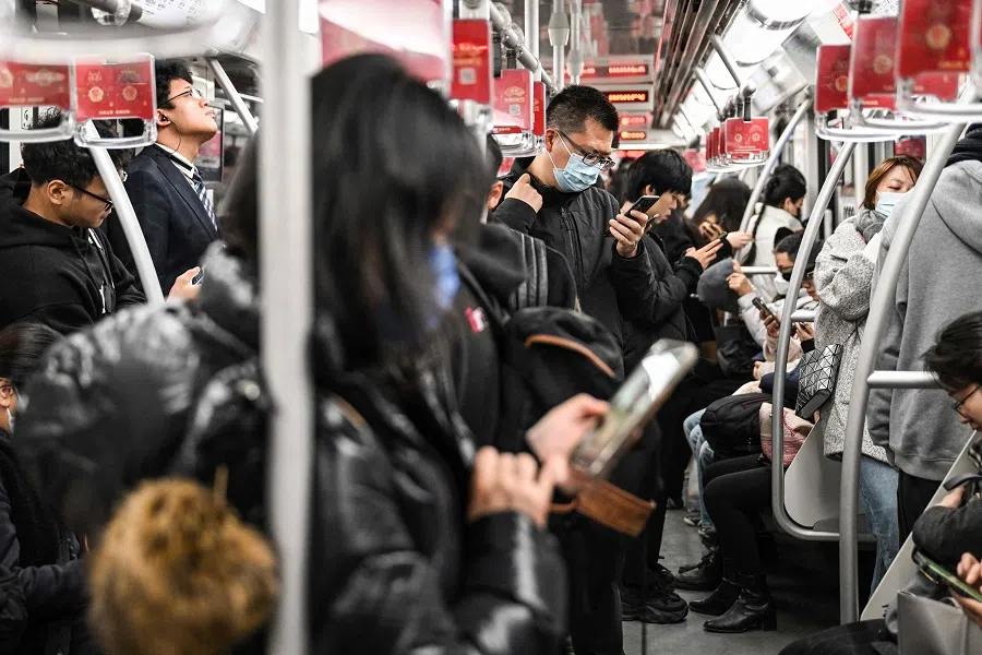 People travel on a subway in Shanghai, China, on 5 December 2023. (Hector Retamal/AFP)