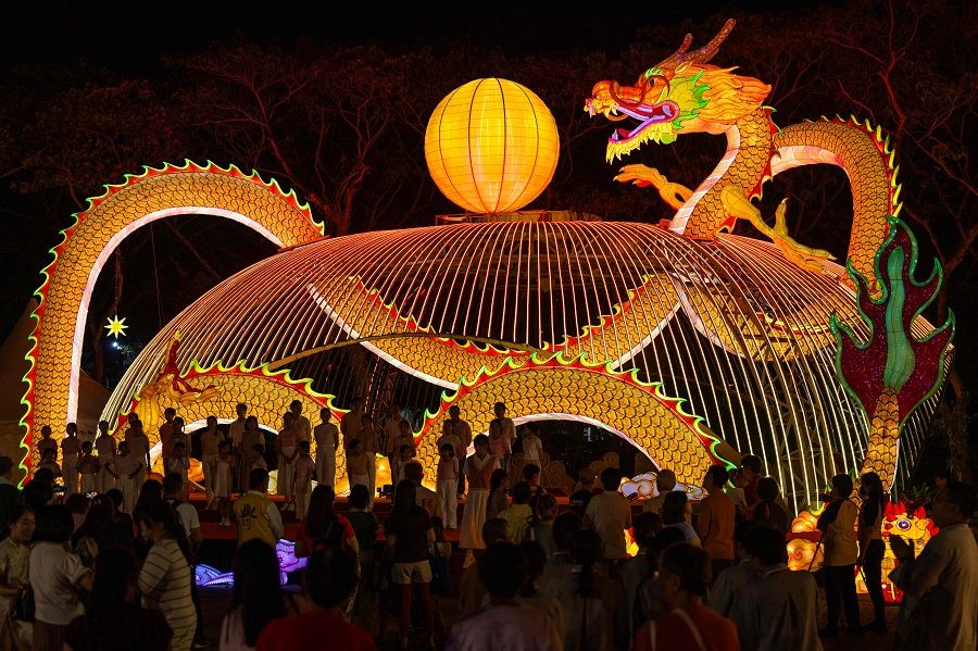 People visit a dragon lantern decoration at the Fo Guang Shan Dong Zen temple in Jenjarom, Malaysia, on 26 January 2024. (Mohd Rasfan/AFP)
