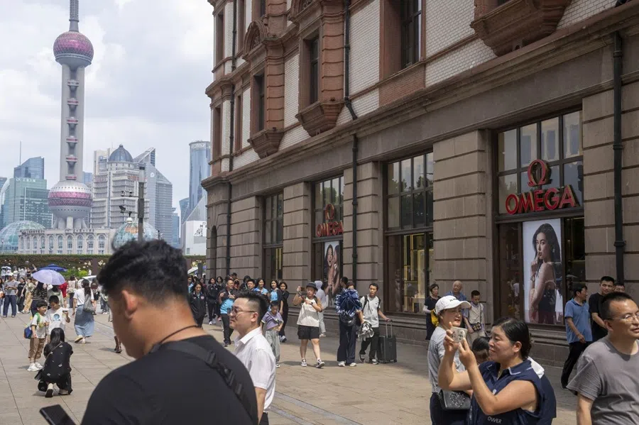People walk along a street in Shanghai, China, on 6 August 2025. (Raul Ariano/Bloomberg)