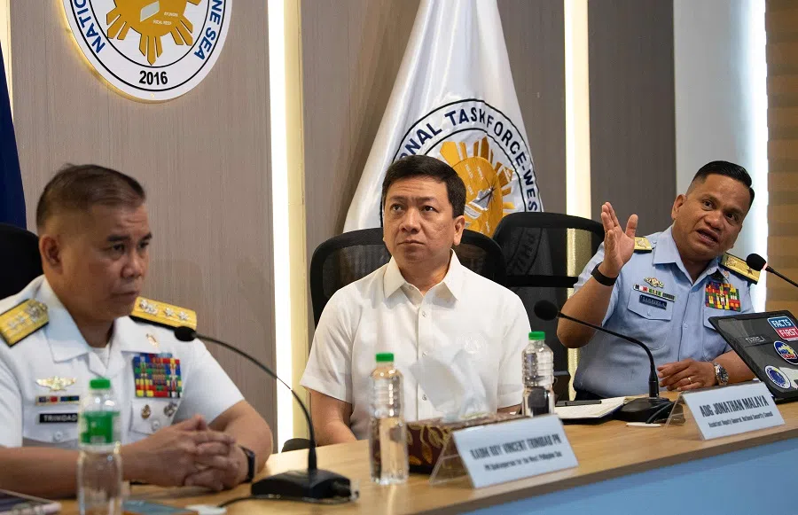 Philippine Commodore Jay Tarriela (right), Coast Guard spokesperson for the West Philippine Sea, speaks while National security Council assistant director General Jonathan Malaya (centre) and Philippine Navy Rear Admiral Roy Trinidad (left), spokesman for South China Sea issues, listen during a press conference in Manila on 28 April 2025. The Philippines on 28 April, slammed a Chinese state television report claiming a disputed reef in the South China Sea was now under Beijing’s control as “irresponsible”, saying the status quo was unchanged. (Ted Aljibe/AFP)