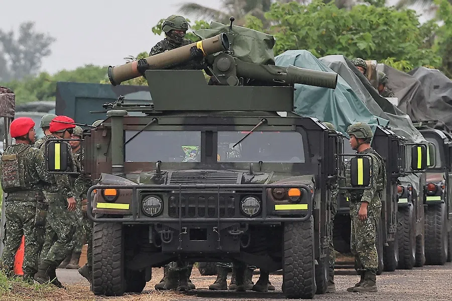 A soldier holds a US-made TOW-2A wire-guided anti-tank missile on an M1167 TOW carrier vehicle at the Fangshan training grounds in Pingtung, Taiwan on 26 August 2024. (Ann Wang/Reuters)