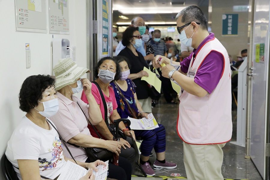 People wait in line at a Covid-19 vaccination centre set up at Far Eastern Memorial Hospital in New Taipei City, Taiwan on 13 May 2021. (I-Hwa Cheng/Bloomberg)