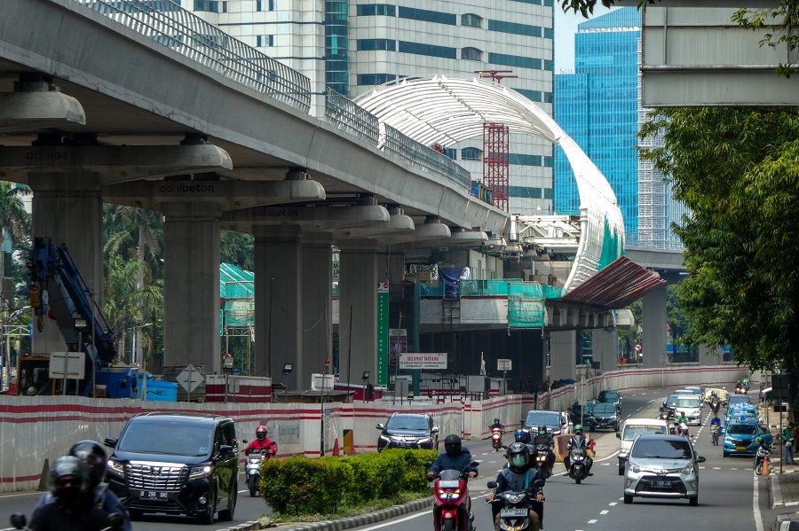Motorists drive under an unfinished light rapid transit terminal construction in Jakarta on 27 May 2020. (Bay Ismoyo/AFP)