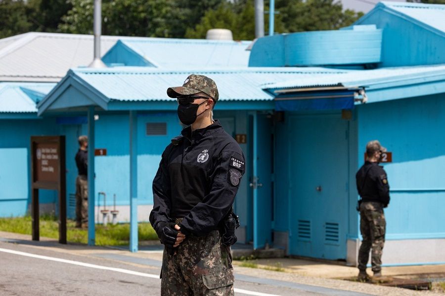 South Korean and United Nations Command soldiers stand guard next to the United Nations Command Military Armistice Commission conference buildings at the truce village of Panmunjom in the Demilitarized Zone in Paju, South Korea, on 19 July 2022. (Seong Joon Cho/Bloomberg)