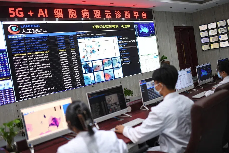 This photo shows laboratory technicians conducting artificial intelligence (AI)-based cervical cancer screening at a test facility in Wuhan, Hubei province, China on 15 June 2023. (AFP)