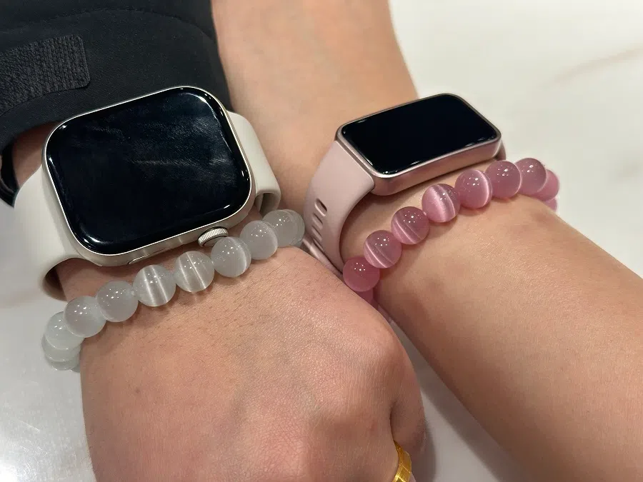 Two Chinese youths show off their crystal bracelets.  (Daryl Lim/SPH Media)