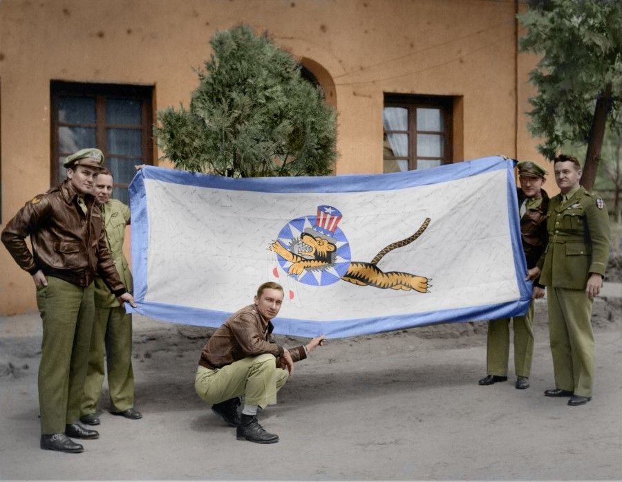 30 March 1943, Kunming - Gathered around the 23rd Fighter Group flag are (from right) Lt. Gen. Claire L. Chennault, Col. Henry Strickland, who later led the 3rd Squadron of the Chinese American Composite Wing, Lt. Col. Bruce Holloway, Maj. Albert Baumler, and Col. Clinton D. Vincent.