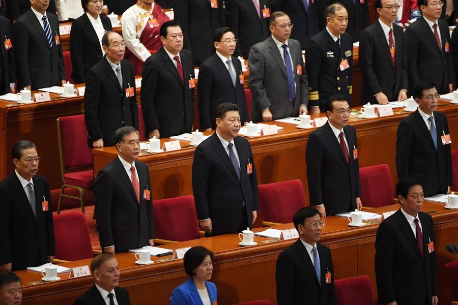 This file photo taken on 5 March 2019 shows Chinese President Xi Jinping (center) singing the national anthem during the opening session of the National People's Congress at the Great Hall of the People in Beijing. China has decided to postpone this meeting but no specific date as to when the meeting will be rescheduled was announced. (Greg Baker/AFP)