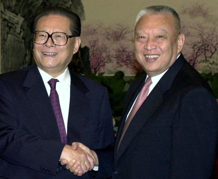 Chinese President Jiang Zemin (left) shakes hands with Hong Kong leader Tung Chee-hwa (right) during Tung's visit to Beijing, China 27 October 2000. (Handout via Reuters)