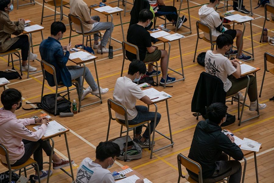 Secondary school students sit for the diploma of secondary education (DSE) exams in Hong Kong on 26 April 2021. (Anthony Kwan/Pool/AFP)