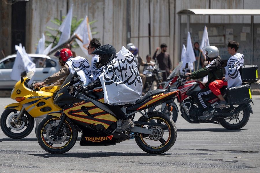 Taliban supporters ride on motorcycles with Taliban flags during celebrations for the second anniversary of the Taliban takeover at the Ahmad Shah Massoud square in Kabul, Afghanistan, on 15 August 2023. (Wakil Kohsar/AFP)