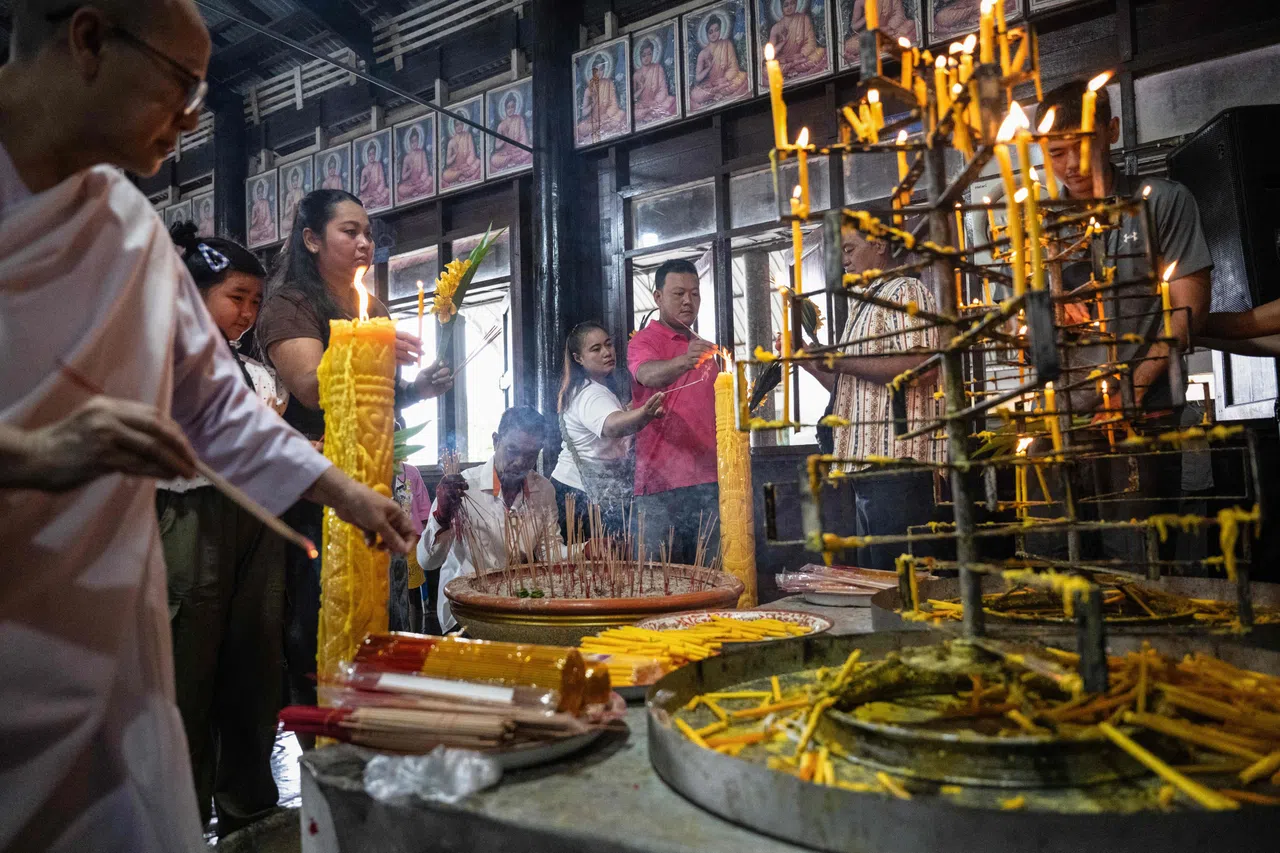 People light candles to mark the start of Buddhist Lent at Wat Nong Song Hong Buddhist temple in Samut Sakhon province on 30 July 2026.