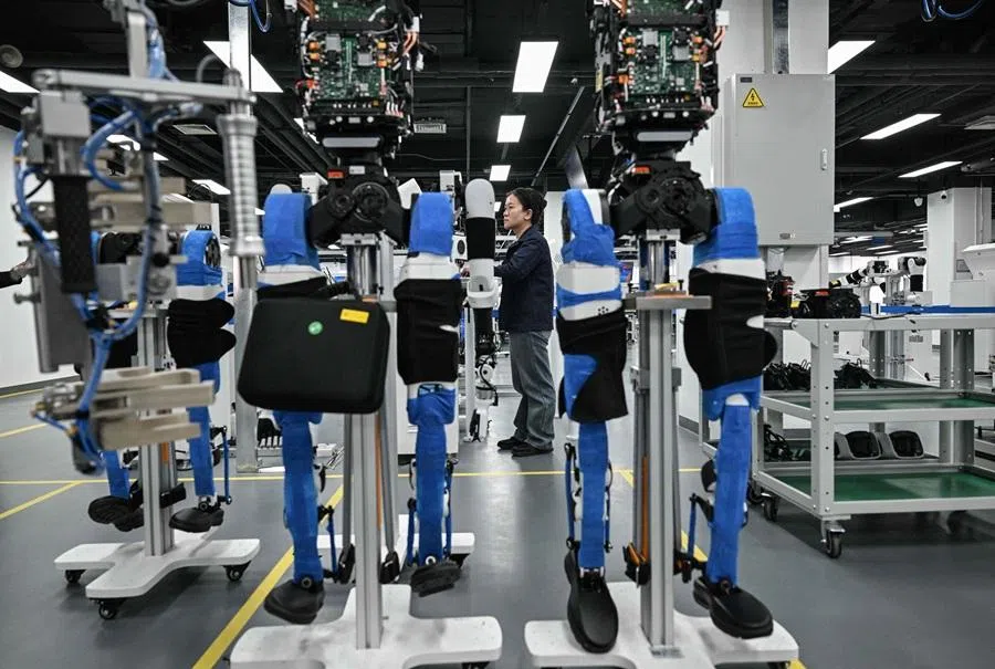 An engineer works at the robotics pilot testing and validation platform of Beijing Innovation Center of Humanoid Robotics (X-Humanoid) in Beijing on 20 March 2026. (Adek Berry/AFP)